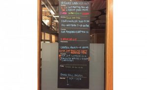 photo of chalkboard with schedule for one week of writing group activities for Duke Story Lab